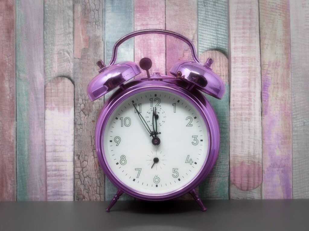 clock showing five minutes to midnight